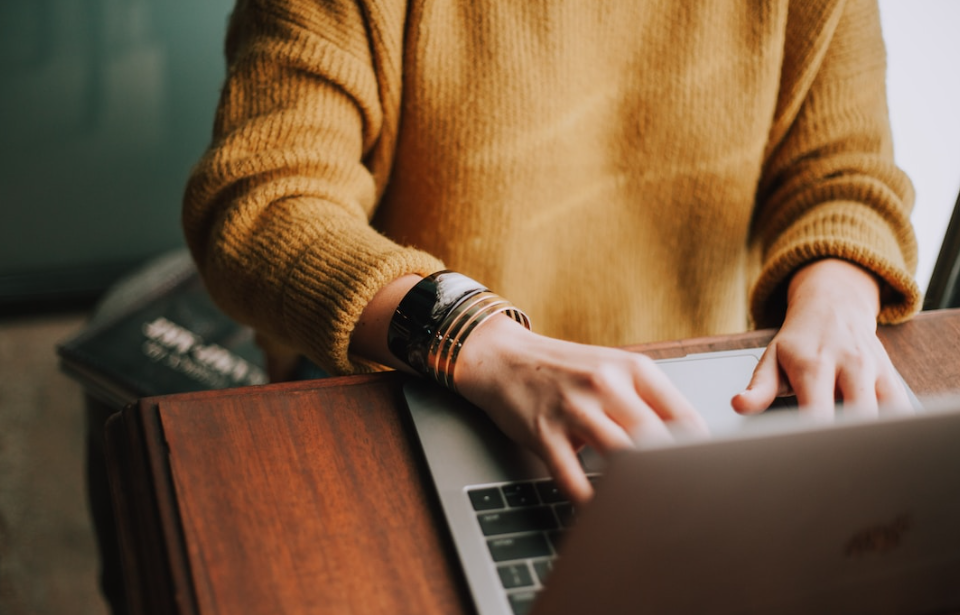 A person working on their laptop optimizing their sales funnel chart